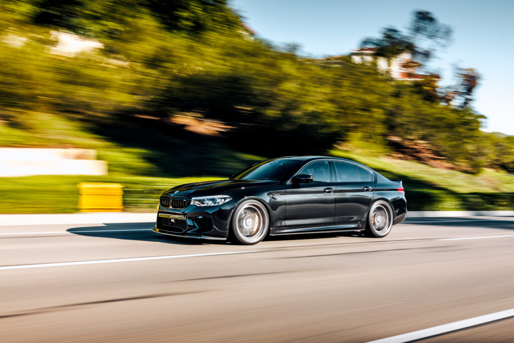 Black car driving along the road